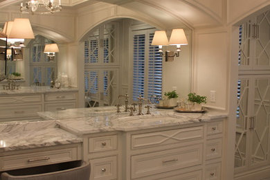Freestanding bathtub - traditional master marble floor freestanding bathtub idea in Other with white cabinets, white walls, an undermount sink and marble countertops