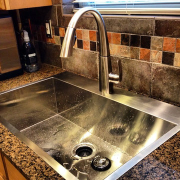 Cutting through existing granite to upgrade to single basin sink and Delta fauce