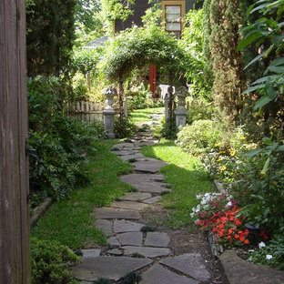 Photo of a small traditional backyard partial sun formal garden for summer in Houston with a garden path and mulch.