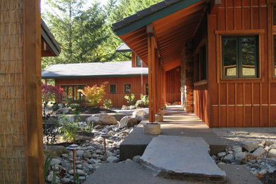 Example of a small arts and crafts red two-story wood exterior home design in Portland with a tile roof