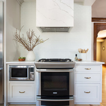 White Glass Tile Kitchen Backsplash with Marble Hooded Range