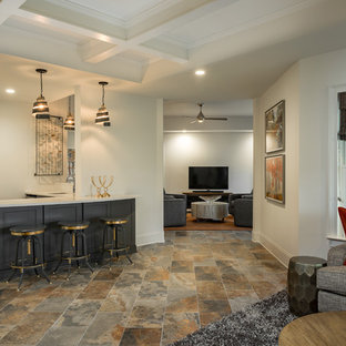 This is an example of a contemporary fully buried basement in Atlanta with slate flooring and beige floors.