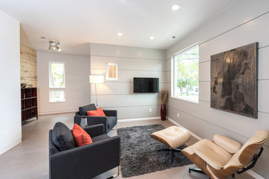 This is an example of a mid-sized modern open concept living room in Other with grey walls, ceramic floors, a wall-mounted tv and no fireplace.
