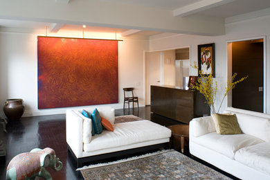 Example of a mid-sized trendy loft-style and formal dark wood floor and brown floor living room design in New York with white walls, no fireplace and no tv
