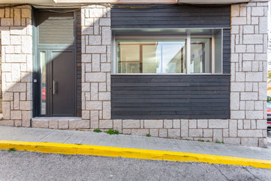 Imagen de fachada de casa negra moderna de tamaño medio de una planta con revestimiento de madera y panel y listón