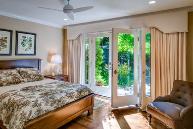 Inspiration for a large medium tone wood floor bedroom remodel in San Francisco with beige walls