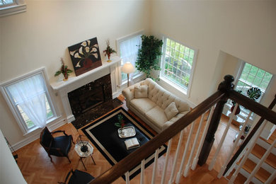 Mid-sized elegant formal and enclosed medium tone wood floor living room photo in New York with white walls, a standard fireplace, a tile fireplace and no tv
