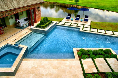 Mid-sized trendy backyard stone and custom-shaped hot tub photo in New Orleans