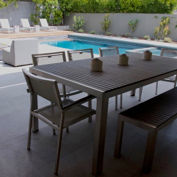Modern preformed grey cement fire pit acts as outdoor feature