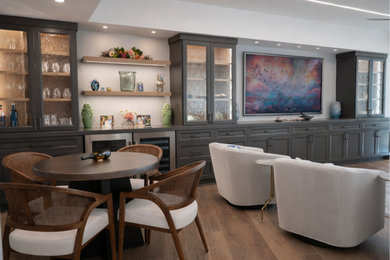 Inspiration for a large transitional open concept medium tone wood floor family room remodel in Houston with white walls