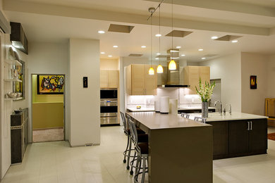 Inspiration for a large modern l-shaped ceramic tile eat-in kitchen remodel in Albuquerque with an undermount sink, flat-panel cabinets, light wood cabinets, white backsplash, stainless steel appliances, an island, solid surface countertops and porcelain backsplash