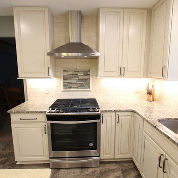 Beige Kitchen with Extra Large Island, Tile Backsplash and Granite Countertops