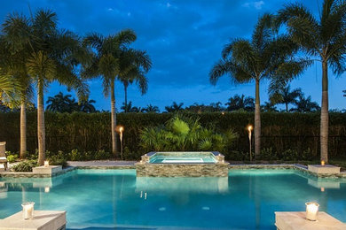 Inspiration for a contemporary backyard custom-shaped natural pool in Dallas with a hot tub and natural stone pavers.