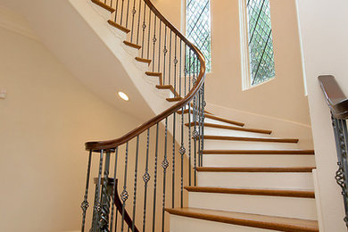 Inspiration for a large timeless wooden curved staircase remodel in Chicago with painted risers