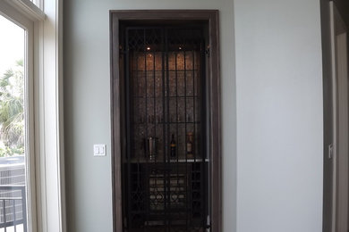 Example of a mid-sized transitional light wood floor wine cellar design in Other
