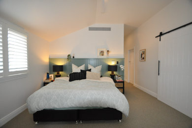Photo of a transitional master bedroom in Sydney with white walls and carpet.
