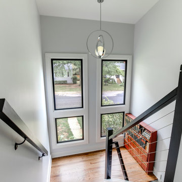 Modern Stair Landing with Floor-to-Ceiling Windows and Cable Railing
