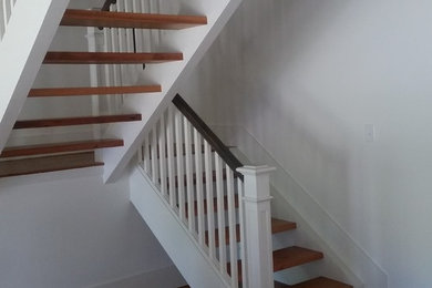 Inspiration for a large craftsman wooden u-shaped open staircase remodel in Austin