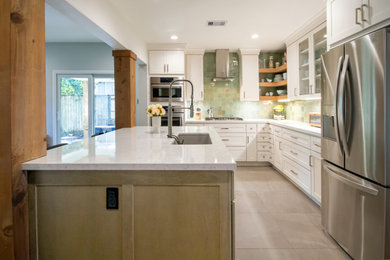 Example of a small transitional l-shaped medium tone wood floor open concept kitchen design in Houston with a single-bowl sink, shaker cabinets, quartz countertops, green backsplash, terra-cotta backsplash, stainless steel appliances, an island and white countertops