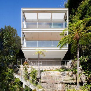 Inspiration for a modern two-storey white house exterior in Sydney with a flat roof.