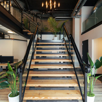 Contemporary wooden staircase with black metal railings
