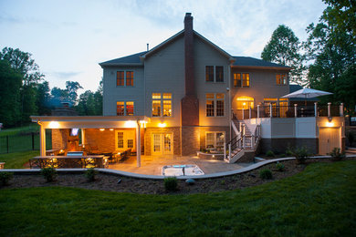 Inspiration for a large timeless red two-story brick exterior home remodel in DC Metro with a hip roof