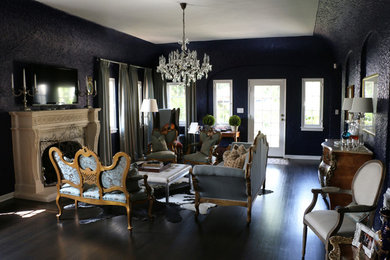 Elegant formal and open concept dark wood floor living room photo in Los Angeles with blue walls, a standard fireplace and a wall-mounted tv