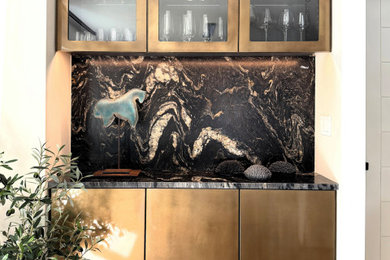 Eat-in kitchen - mid-sized contemporary l-shaped light wood floor and brown floor eat-in kitchen idea in Tampa with an undermount sink, flat-panel cabinets, beige cabinets, granite countertops, black backsplash, stone slab backsplash, paneled appliances, a peninsula and black countertops
