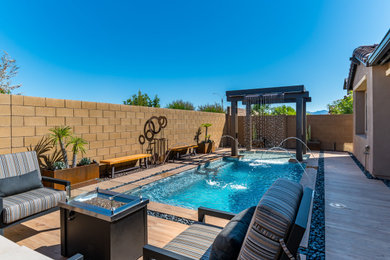 Small backyard tile and rectangular pool photo in Phoenix