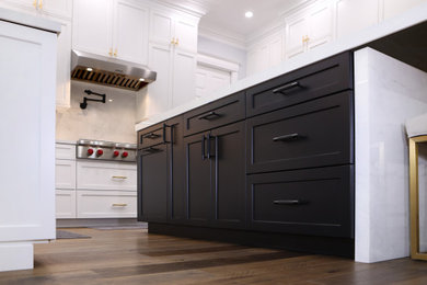 Example of a large transitional u-shaped medium tone wood floor and black floor eat-in kitchen design in San Francisco with shaker cabinets, dark wood cabinets, solid surface countertops, white backsplash, mosaic tile backsplash, stainless steel appliances, an island and white countertops