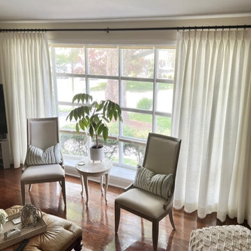 White Linen Pinch Pleat Drapery Panels on a Black TRAX Rod in Living Room