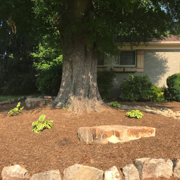Interlocking paver patio, dry creek bed and boulder wall