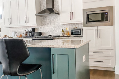 Open concept kitchen - mid-sized 1960s single-wall open concept kitchen idea in Atlanta with shaker cabinets, blue cabinets, granite countertops, white backsplash, black appliances, an island and terra-cotta backsplash