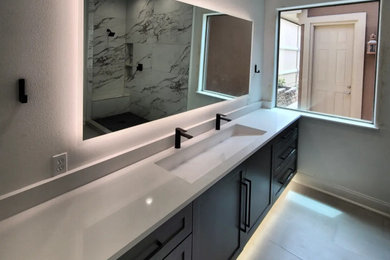 Inspiration for a mid-sized modern master ceramic tile, gray floor and single-sink corner shower remodel in Austin with shaker cabinets, gray cabinets, an undermount sink, quartz countertops, a hinged shower door, white countertops and a floating vanity