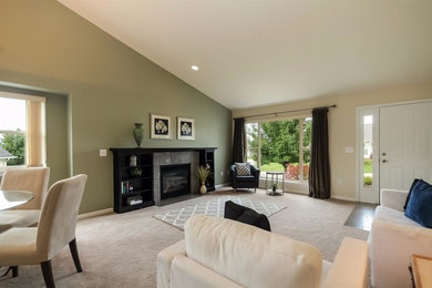 Example of a large transitional open concept carpeted family room design in Detroit with green walls, a standard fireplace, a tile fireplace and no tv