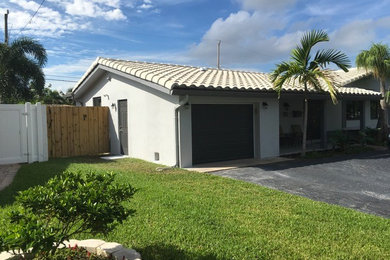 Small transitional attached one-car garage photo in Other
