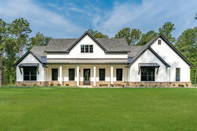 Example of a farmhouse exterior home design in Dallas
