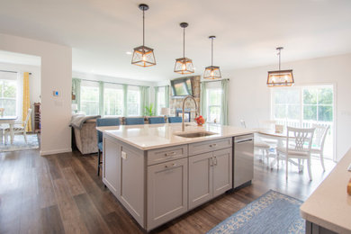 Example of a farmhouse eat-in kitchen design in Philadelphia with an island