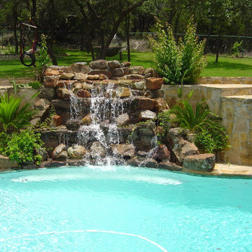 Pool with Moss Rock Waterfall and Flagstone Deck