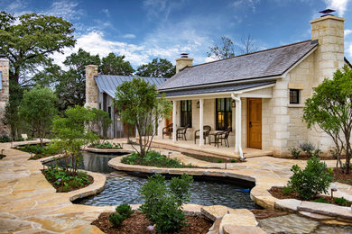Small rustic one-story stone exterior home idea in Austin