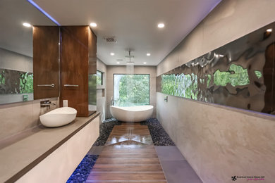 Bathroom - large modern pebble tile floor bathroom idea in Houston with a wall-mount toilet, a vessel sink and a niche