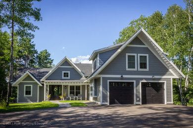 Inspiration for a mid-sized farmhouse gray two-story concrete fiberboard exterior home remodel in Minneapolis with a shingle roof