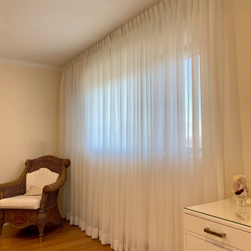 Tailored pleated sheer drapery for bedroom