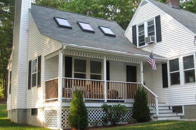 Mid-sized elegant front porch photo in Boston with decking and a roof extension