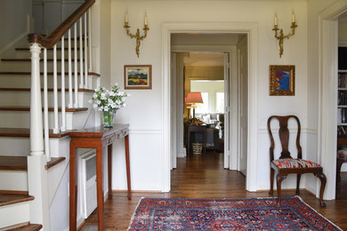Mid-sized elegant dark wood floor foyer photo in San Diego with white walls