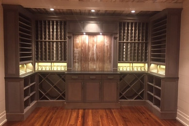 This is an example of a mid-sized country wine cellar in Atlanta with medium hardwood floors, diamond bins and brown floor.