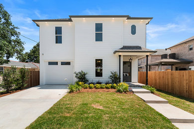 Mid-sized transitional white concrete fiberboard house exterior idea in New Orleans with a hip roof and a shingle roof