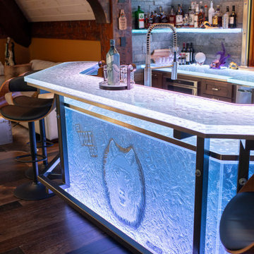 Glass private bar and glass stair treads inside a man cave in Michigan