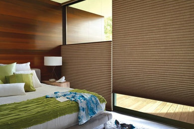 Example of a mid-sized mid-century modern master bedroom design in New York with brown walls and no fireplace