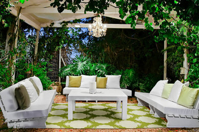 This is an example of a large tropical backyard patio in Other.